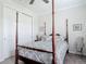 Bedroom with a four-poster bed, soft carpet, and a window offering natural light at 425 Wedgeworth Ln, Deland, FL 32724