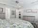 Bedroom featuring a floral comforter, light gray walls and furniture and crown molding at 425 Wedgeworth Ln, Deland, FL 32724