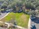 Aerial view of a green common area with a gazebo, landscaping, and parking spaces at 425 Wedgeworth Ln, Deland, FL 32724