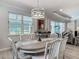 Dining room with large windows offering views, a modern light fixture, and open access to the living room at 425 Wedgeworth Ln, Deland, FL 32724