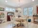 Bright dining room with an oval table, wood floors, a decorative cabinet, and a modern chandelier at 425 Wedgeworth Ln, Deland, FL 32724