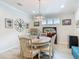Well-lit dining room featuring a decorative compass and a round table with six chairs at 425 Wedgeworth Ln, Deland, FL 32724