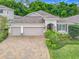 Charming single-story home with well-manicured landscaping and a brick paver driveway at 425 Wedgeworth Ln, Deland, FL 32724