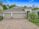 Lovely single-story home boasting a three-car garage, stone accents, and lush landscaping at 425 Wedgeworth Ln, Deland, FL 32724