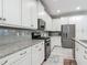 Modern kitchen with white cabinets, granite countertops, and stainless steel appliances at 425 Wedgeworth Ln, Deland, FL 32724