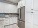 Stylish kitchen with white cabinetry, granite countertops, stainless appliances and gray subway tile at 425 Wedgeworth Ln, Deland, FL 32724