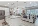 Open-concept kitchen and living area features a granite island and stainless steel appliances at 425 Wedgeworth Ln, Deland, FL 32724