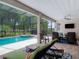 Lanai with lounge chairs providing a view of the screened-in pool and hot tub at 425 Wedgeworth Ln, Deland, FL 32724