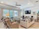 Bright living room with a ceiling fan, sliding glass doors, and comfortable seating at 425 Wedgeworth Ln, Deland, FL 32724