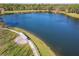 Aerial view of a serene pond with a walking path and lakeside gazebo at 425 Wedgeworth Ln, Deland, FL 32724