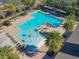 Aerial view of community pool featuring a splash pad, palm trees, and ample seating at 425 Wedgeworth Ln, Deland, FL 32724