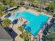 Aerial view of a large community pool with palm trees, lounge chairs, and a splash pad at 425 Wedgeworth Ln, Deland, FL 32724