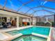 Inviting screened-in pool and hot tub area with a covered lanai and view of the backyard at 425 Wedgeworth Ln, Deland, FL 32724