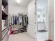 Spacious walk-in closet featuring extensive storage solutions and an open doorway to the bathroom at 425 Wedgeworth Ln, Deland, FL 32724
