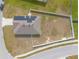 Aerial view of a fenced property, highlighting the roof's solar panels and surrounding yard at 4273 Ne 29Th Pl, Ocala, FL 34470