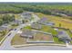 An aerial shot highlighting community homes and a serene wooded landscape in the distance at 4273 Ne 29Th Pl, Ocala, FL 34470