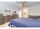 This bedroom features neutral walls, plush carpet, ceiling fan, and ample storage with matching dressers at 4273 Ne 29Th Pl, Ocala, FL 34470