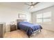 Primary bedroom with a ceiling fan, bedside tables, carpet, and natural light at 4273 Ne 29Th Pl, Ocala, FL 34470