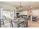 Dining area with sliding glass doors, decorative light fixture, and barstool seating at kitchen island at 4273 Ne 29Th Pl, Ocala, FL 34470