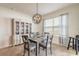 Bright dining room with a decorative light fixture, a hutch, and a large window at 4273 Ne 29Th Pl, Ocala, FL 34470