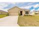 Charming single-story home featuring a two-car garage and well-maintained lawn in a suburban setting at 4273 Ne 29Th Pl, Ocala, FL 34470