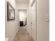 Hallway leads to a bathroom, with carpeted floors and white walls, offering a simple and clean transition at 4273 Ne 29Th Pl, Ocala, FL 34470