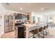 Kitchen with stainless steel appliances, dark cabinets, and an island with barstool seating at 4273 Ne 29Th Pl, Ocala, FL 34470