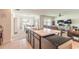 Open kitchen featuring bar stool seating, modern appliances, and an attached living and dining area at 4273 Ne 29Th Pl, Ocala, FL 34470