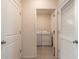 Functional laundry room with white washer and dryer units, accessible through an open doorway at 4273 Ne 29Th Pl, Ocala, FL 34470