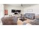 Spacious living room with gray reclining sofas, a ceiling fan, and neutral colored carpet at 4273 Ne 29Th Pl, Ocala, FL 34470