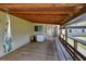 Relaxing back porch with a hammock, a mini-fridge, and exposed rafters at 430 S Woodward Ave, Deland, FL 32720