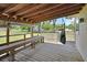 Inviting back porch featuring a hammock swing, exposed rafters, and a scenic view of the home's spacious backyard at 430 S Woodward Ave, Deland, FL 32720