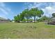Lush backyard featuring mature trees and an area perfect for a cozy fire pit at 430 S Woodward Ave, Deland, FL 32720