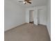 A cozy bedroom with neutral carpet, a ceiling fan, and a closet for storage at 430 S Woodward Ave, Deland, FL 32720