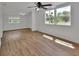 Bright bedroom featuring stylish wood-look flooring, ceiling fan, and fresh, white walls at 430 S Woodward Ave, Deland, FL 32720