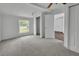 This spacious bedroom features neutral carpet, a ceiling fan, and bright natural light from the window at 430 S Woodward Ave, Deland, FL 32720