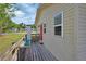 Well-maintained home exterior with a charming red door, wood siding, and a cozy, inviting porch at 430 S Woodward Ave, Deland, FL 32720