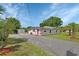 Inviting home with solar panels, a long driveway, and a detached garage, all nestled on a well-maintained lot at 430 S Woodward Ave, Deland, FL 32720
