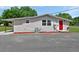 Charming single-story home with a red front door and cozy exterior at 430 S Woodward Ave, Deland, FL 32720