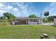 Charming home showcasing an inviting back porch, shed, and lush green lawn, perfect for outdoor living at 430 S Woodward Ave, Deland, FL 32720