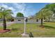 Charming home with solar panels, palm trees, and a well-manicured lawn, perfect for sustainable living at 430 S Woodward Ave, Deland, FL 32720