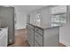Well-lit kitchen with white cabinets, stainless steel appliances, and central island at 430 S Woodward Ave, Deland, FL 32720