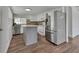 Well-lit kitchen with white cabinets, stainless steel appliances, and a central island at 430 S Woodward Ave, Deland, FL 32720