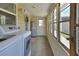Bright laundry room with modern washer and dryer, fresh paint, and ample natural light through large windows at 430 S Woodward Ave, Deland, FL 32720