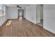 Bright living room featuring stylish wood-look flooring and fresh, white walls at 430 S Woodward Ave, Deland, FL 32720