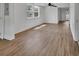 Bright living room featuring stylish wood-look flooring and fresh, white walls at 430 S Woodward Ave, Deland, FL 32720