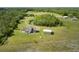 Spacious property with a home, detached garage, and picturesque pond, surrounded by lush landscape at 4503 Colony Rd, New Smyrna Beach, FL 32168
