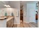 Bathroom features a double vanity with granite countertop and tiled shower with modern fixtures at 4503 Colony Rd, New Smyrna Beach, FL 32168