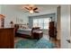 Comfortable bedroom featuring hardwood floors, blue walls, a ceiling fan, and traditional wooden furniture at 4503 Colony Rd, New Smyrna Beach, FL 32168