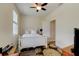 Bedroom has a white bed, ceiling fan, and natural light at 4503 Colony Rd, New Smyrna Beach, FL 32168